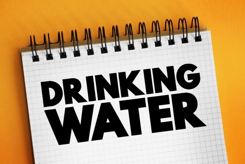 words drinking water written on graph paper