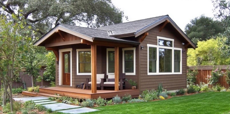 tiny home in fenced back yard with well manicured lawn