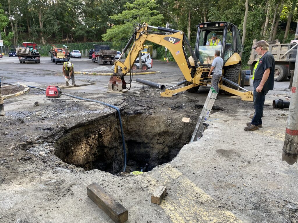 utility potholing for emergency repairs in busy commercial plaza in Newton MA