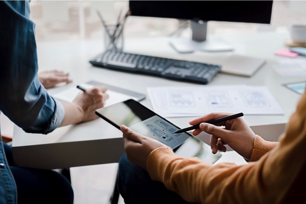 permit and budget planning with calculator paper and iPad